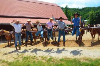 crew by barn, jumping for joy