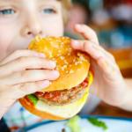 child eating a hamburger at Horseshoe Canyon Ranch